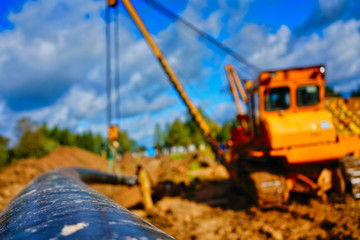 Obraz premium Pipelayer tractor lifts a pipe