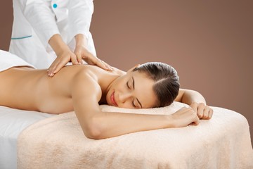 Beautiful young woman relaxing with massage at beauty spa