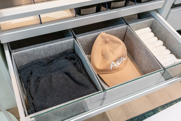 Modern drawer in closet with mens accessories inside.