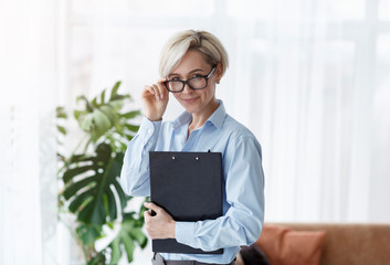 Counselor Lady Holding Folder Smiling To Camera Standing In Office