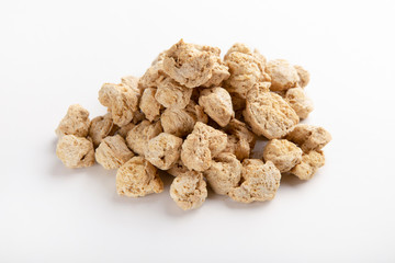 Heap of dehydrated texturized soymeat isolated on white
