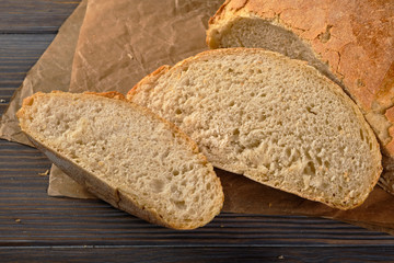 Loaf of bread, sliced bread on a wooden table, food closeup
