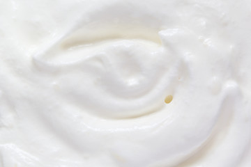 Whipped cream swirl texture. White soft dairy product. Cooking food background. Top view