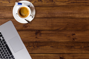 Office desk, workplace desk table with laptop, glasses, notebook, pencil, coffee