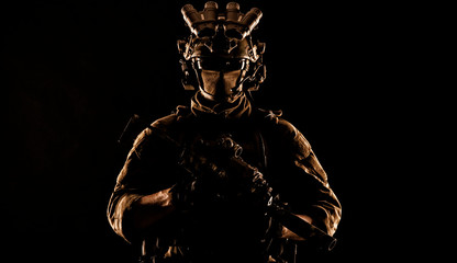 Army elite soldier with hidden behind mask and glasses face, in full tactical ammunition, equipped...