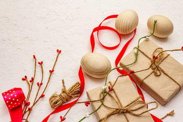 Zero waste Easter concept. Wooden eggs, gifts in craft paper. Not plastic, eco trend. White putty...
