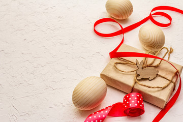 Zero waste Easter concept. Wooden eggs, gifts in craft paper. Not plastic, eco trend. White putty background