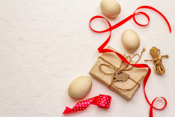 Zero waste Easter concept. Wooden eggs, gifts in craft paper. Not plastic, eco trend. White putty...