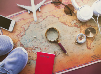 book and magnifying glass on wooden background