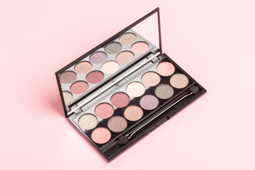 set of pastel eyeshadows isolated on rose background