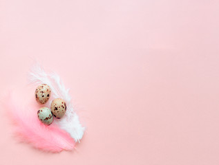 Egg gift in green paper packaging and with pink ribbon Easter Bunny wrap idea. Chocolate dragee white and gold color, multicolor colorful feathers. Minimal concept. Flat lay, Copy space, top view