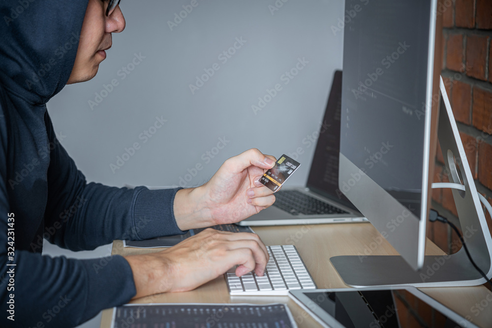 Aufkleber Computer hacker or cyber attack concept, Dangerous hooded hacker using multiple computers typing bad data into online system the access with a virus to infect steal information