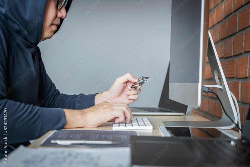 Aufkleber Computer hacker or cyber attack concept, Dangerous hooded hacker using multiple computers typing bad data into online system the access with a virus to infect steal information