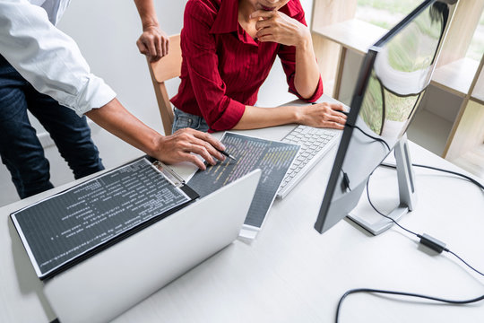 Programmers cooperating at Developing programming and website working in a software develop company office, writing codes and typing data code, Programming with HTML, PHP and javascript