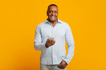 Mature african american man networking on cellphone
