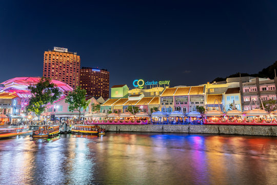 Singapore, Singapore - Aug 1, 2019 : Colorful light building at night historical riverside quay in Clarke Quay, located within the singapore river at blue hour, Popular attraction for nightlife