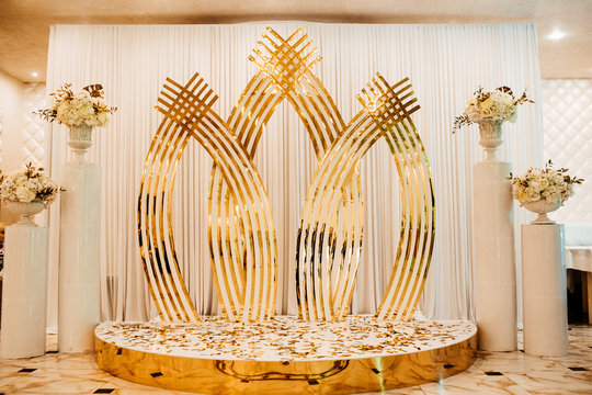 Wedding decor. Photographic area is a stylish wedding decoration. Decorated with flowers. Hand made wedding decorations. Place for taking pictures. Exquisite restaurant. Detail. White and gold design