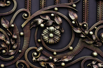 Beautiful forged gate with metal flowers and decor