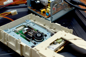 Disassembled cd-rom optical drive for a desktop personal computer. Repair and maintenance of electronics.