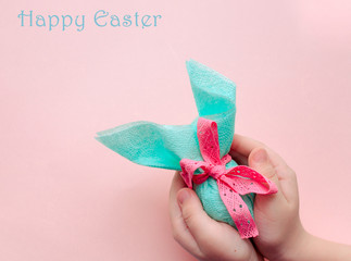 Egg gift in green paper packaging and with pink ribbon Easter Bunny wrap idea. Chocolate dragee...