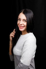 Portrait of serious beautiful female with black hair, has minimal makeup, looks calmly at camera,...