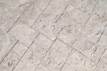Gray concrete road pavement with decorative relief