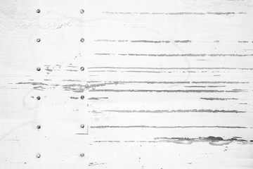 Texture of white scratched metal wall with rivets