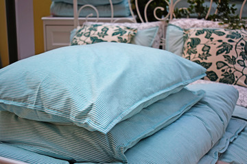 Beautiful bed linen.Pillows and blankets piled up.