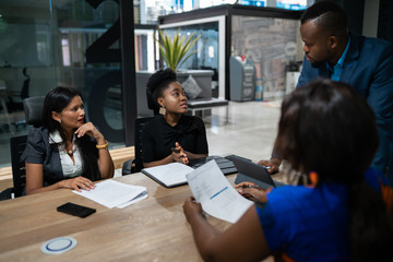 Group of diverse businesspeople meeting together in an office boardroom