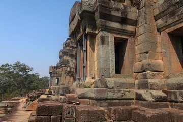 temple ruins with pillars, reconstruced, saftey, construction in angkor wat, cambodia, forest in the background