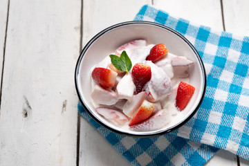 Strawberries and cream dessert on white background