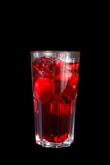 Monochrome transparent cocktail, refreshing in a tall glass with a lot of ice cubes with taste of berries, cherries, strawberries, grapefruit. Side view Isolated black background. Drink for the menu