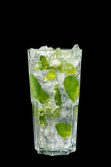 Summer drink with lime and mint, ice on isolated black background. Direct perspective, cool, refreshing