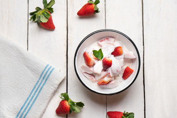 Strawberries and cream dessert on white background