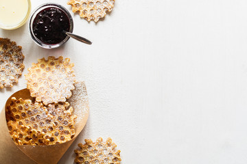 Flat lay with homemade waffles and toppings on white background