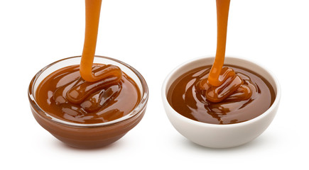 Pouring caramel sauce isolated on white background
