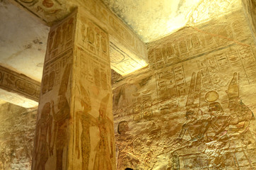 Interior of Abu Simbel with intrigue mural and egyptian hieroglyphs.