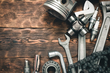 Car spare parts on wooden workbench flat lay background with copy space.