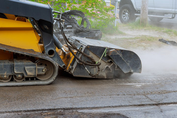 Removing old asphalt from a street surface road milling machine