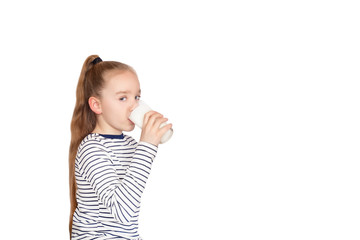 Little girl drinks milk from a glass isolated on white
