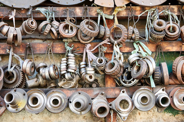 Close-up of an array of used rusty old bearings and other car parts hanging in line in a auto junk shop in Iloilo City, Philippines, Asia