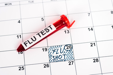 sample with flu test on calendar with marked date and flu shot lettering