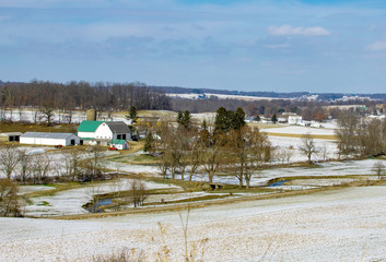 Fototapeta na wymiar Rural winter scene with red barn and farming