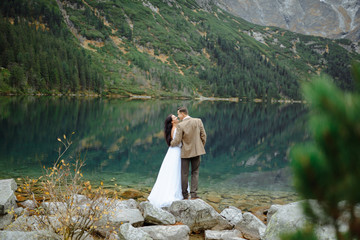 Loving couple on the background of the Sea-eye lake in Poland