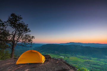 Fototapeta na wymiar The orange tent's hikers on the cliff at Phu-E-Lerd, Loei province, Thailand.