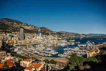 Fototapeta na wymiar Monte Carlo city panorama. View of luxury yachts and apartments in harbor of Monaco, Cote d'Azur. Panorama Port Hercules from the observation deck in Monaco.