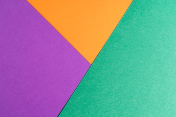 Multi colored abstract paper of pastel colors, with geometric shape, flat lay.