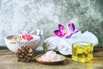 Obraz na płótnie Canvas Himalaya salt and soap and towel on wood table with glay background,aroma spa set concept.