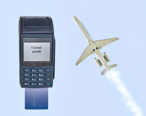 Buying a plane ticket. Modern payment terminal with inserted card. A aircraft is flying against a blue background.