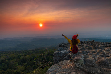 Young  woman hiking on mountains. Lan-hin-pum, Phu Hin Rong Kla National park, Phitsanulok province , Thailand.